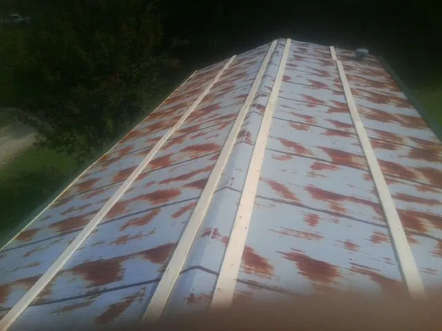 Rusted metal roof panels with new wood purlins before replacement — Storm Damage Roof Repair in Goldens Bridge by Roofing Brothers